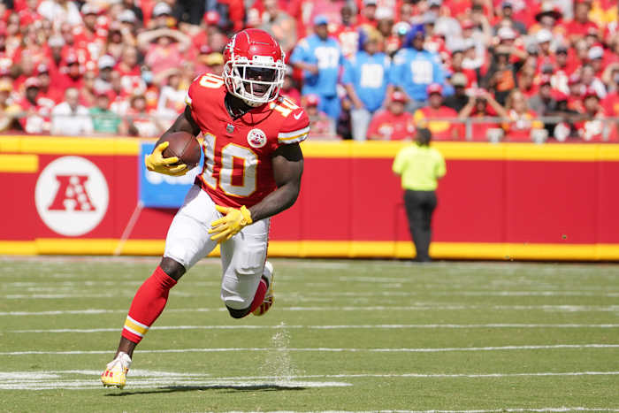 Sep 26, 2021; Kansas City, Missouri, USA; Kansas City Chiefs wide receiver Tyreek Hill (10) runs the ball against the Los Angeles Chargers during the first half at GEHA Field at Arrowhead Stadium. Mandatory Credit: Denny Medley-USA TODAY Sports